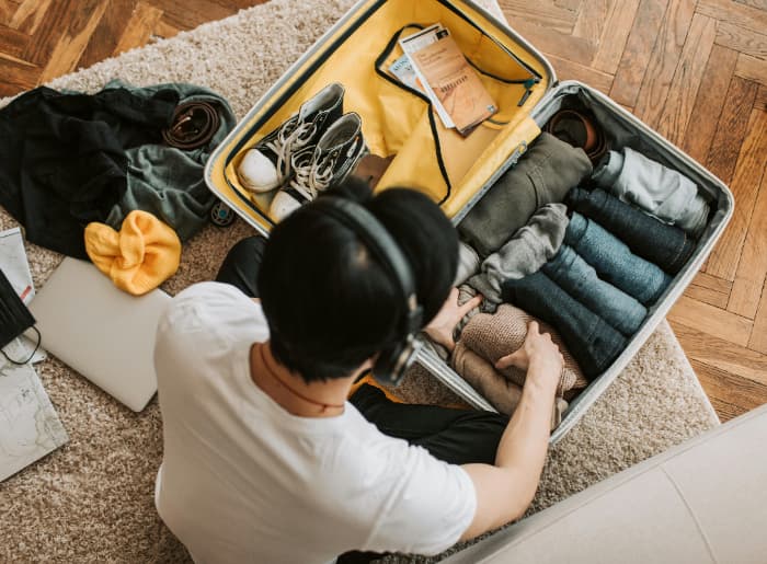 A man packing his suitcase
