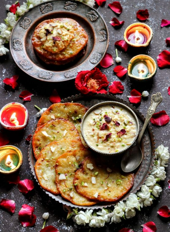 Sweet pancakes deep fried and served with rabdi, a desert made by boiling milk to a semi-solid state