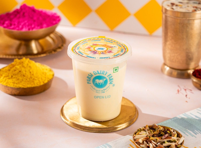 4. Parsi Dairy Farm: Maharaja Lassi Challenge
Indulgent milk treats, traditional Indian mithai, and nostalgia served in every bite – Parsi Dairy Farm has been one of the city’s most beloved confectioneries. For Holi 2026, it is rolling out a festive line-up of indulgent classics. With vibrant in-store festive branding, a live Thandai counter, and a ‘Maharaja Lassi Challenge’, guests will definitely enjoy the spirit of Holi across Parsi Dairy Farm outlets in Mumbai.
The Maharaja Lassi Challenge invites guests for a delicious challenge – finish the entire glass of lassi (INR 540 for a glass) in just 60 seconds! And no, it is no ordinary lassi: thick, creamy lassi topped with milk cake, malai kulfi, and strawberry crush. If you win the challenge, you take home a special Holi Special Gift Hamper as well as a festive turban for celebratory photo-ops!
When: 27th February to 8th March
Holi Menus In Mumbai