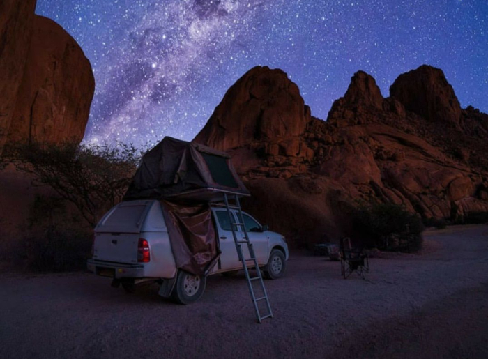  Milky Way visible over a dark desert landscape